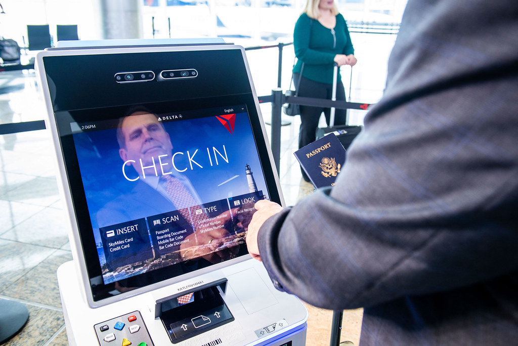 Customer checking in at a self-service kiosk using facial recognition