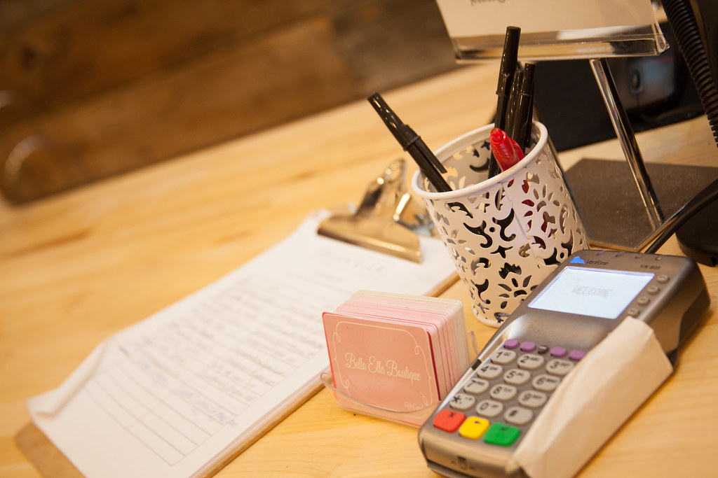 Credit card being processed at a retail counter