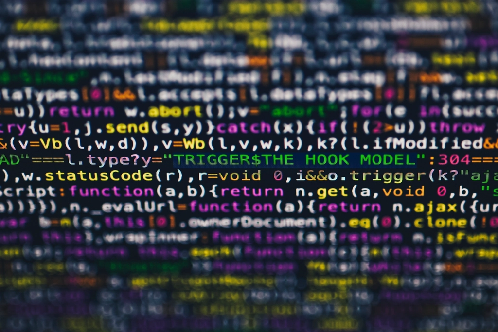 Programmer working with code on a screen