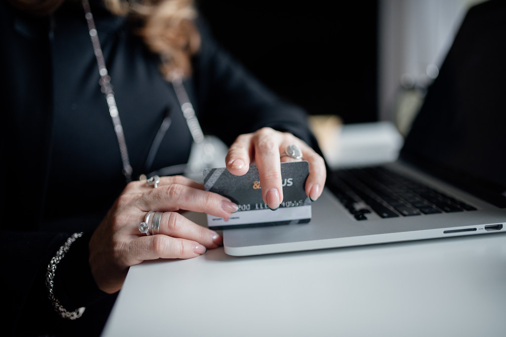 Person completing an online card payment on a laptop